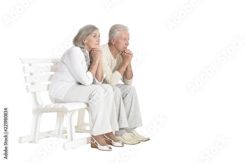portrait of  senior couple sitting on bench