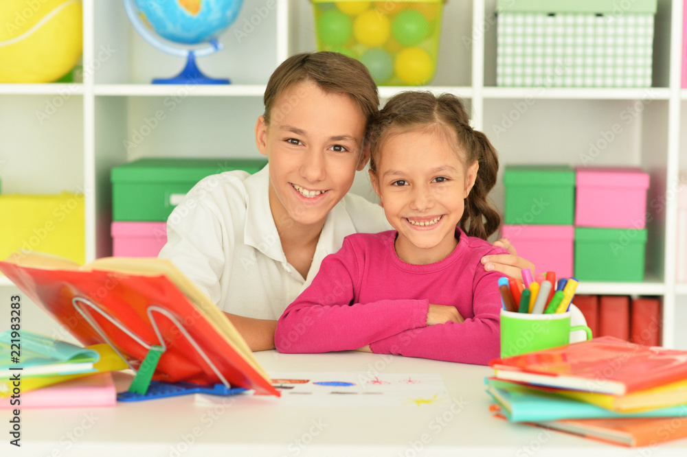Cute little girl with brother doing homework Cute little girl with brother doing homework