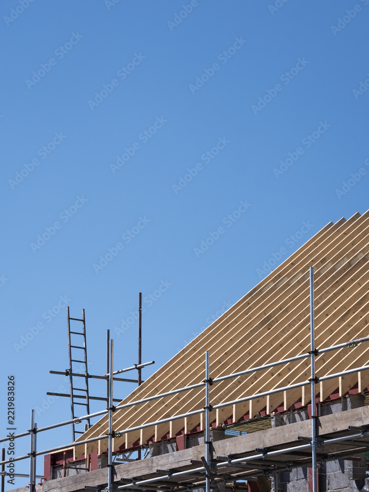 roof trusses on a new building with blue sky roof trusses on a new building with blue sky