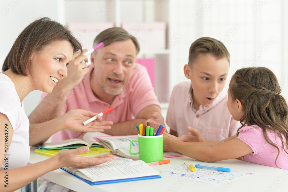 Big happy family doing homework at home Big happy family doing homework at home