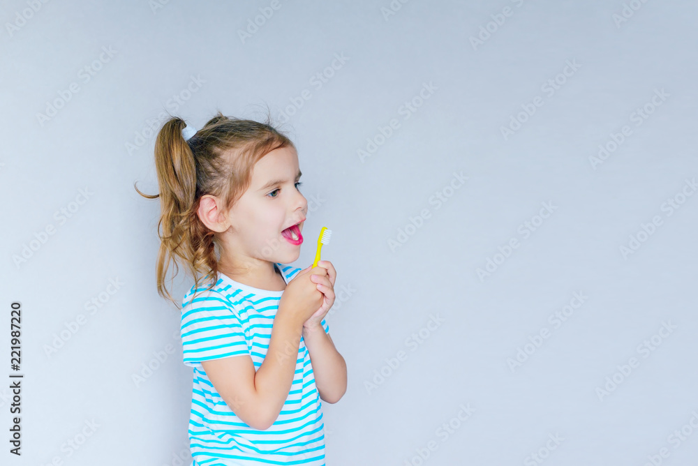 Beautiful baby girl brushing her teeth. Baby girl brushing her teeth and singing a favorite song. Health care, dental hygiene, people and beauty concept. Mockup, free spase. Selective focus. Beautiful baby girl brushing her teeth. Baby girl brushing her teeth and singing a favorite song. Health care, dental hygiene, people and beauty concept. Mockup, free spase. Selective focus.