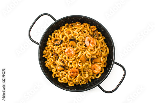 Traditional Spanish fideua. Noodle paella isolated on white background. Top view