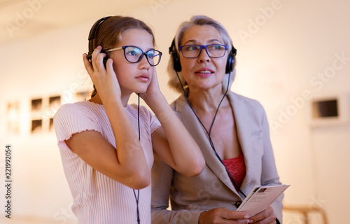 People using audio guide in museum photo