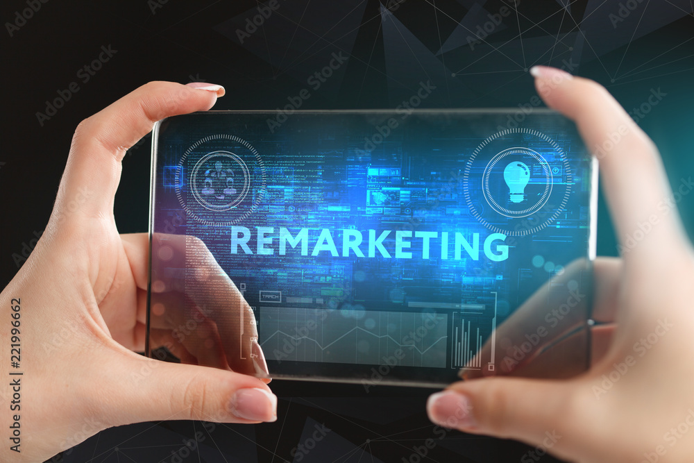 Fototapeta premium The concept of business, technology, the Internet and the network. A young entrepreneur working on a virtual screen of the future and sees the inscription: Remarketing