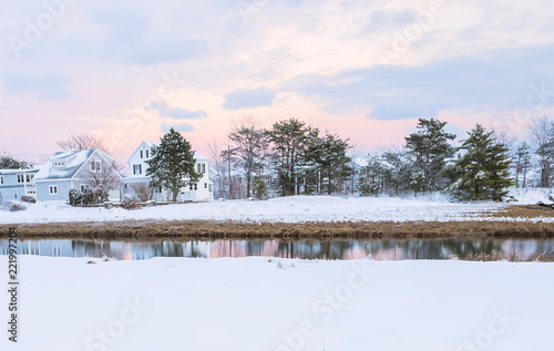 Lovely houses by the river on a winter evening. A traditional view of Maine. USA.   © Ann Stryzhekin