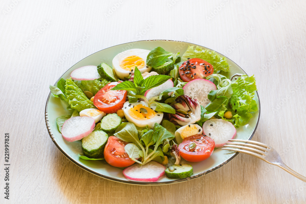 Healthy salad with vegetables and eggs on wooden table. Close up, copy space. Balanced diet for weight loss. Healthy salad with vegetables and eggs on wooden table. Close up, copy space. Balanced diet for weight loss.