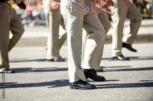 Military marching in a street. Legs and shoes in line