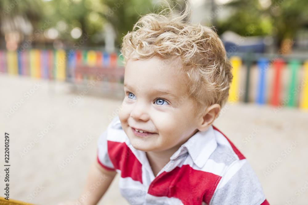 blond boy plays at park blond boy plays at park