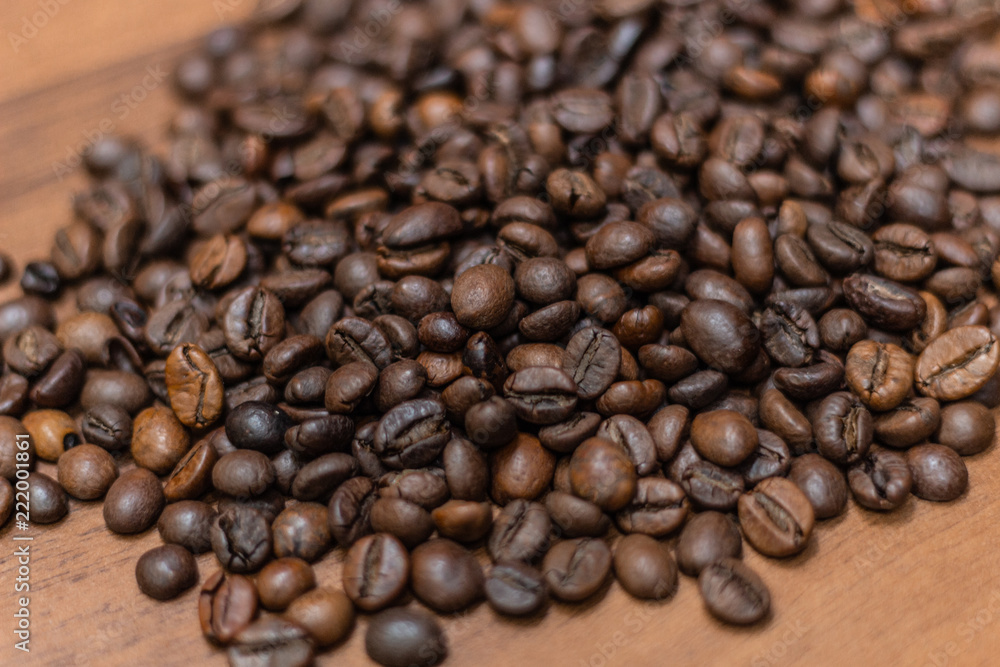 Background of fried coffee beans on a wooden surface