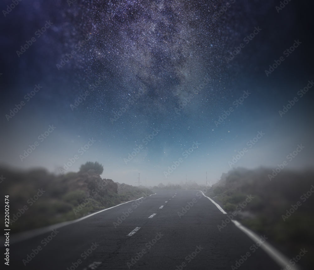 starry night sky above the road.