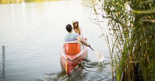 Loving couple rowing on the...