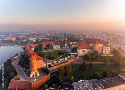 Aerial view Royal Wawel Castle and Gothic Cathedral in Cracow, Poland, with Renaissance Sigismund Chapel with golden dome, fortified walls, yard, park and tourists. photo