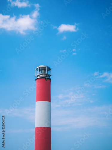 Lighthouse on blue sky background