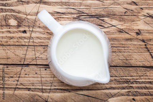 Fresh milk in the milk jug close-up. © Elenglush