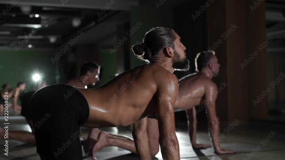 Low key strong men practice yoga hot cat pose in studio rapid slow motion Low key strong men practice yoga hot cat pose in studio rapid slow motion