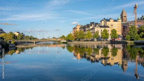 Norrköping waterfront and Motala river on a quiet Sunday evening in early September. Norrkoping is a historic industrial town in Sweden. © rolf_52