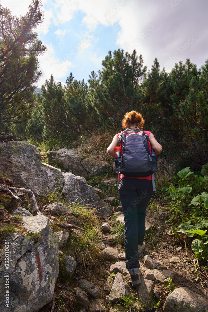 Woman hiking into the mountains Woman hiking into the mountains