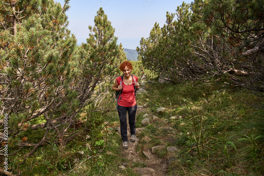 Woman hiking into the mountains Woman hiking into the mountains