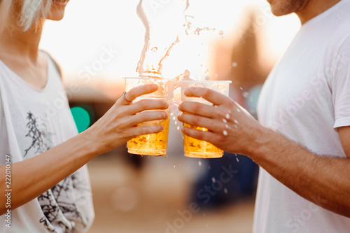 Couple cheering with beer. Close up 