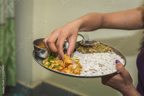 Nepali Hindu Woman having Dar or heavy Meal set on the Plate.Nepali Snacks Set.Khaja Set © Nabaraj Regmi