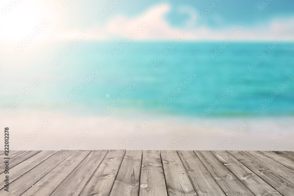 blurred tropical beach and ocean with wooden plank