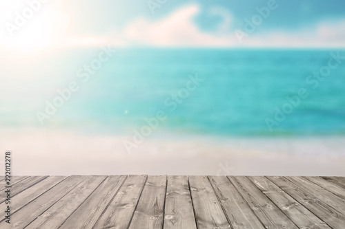 blurred tropical beach and ocean with wooden plank