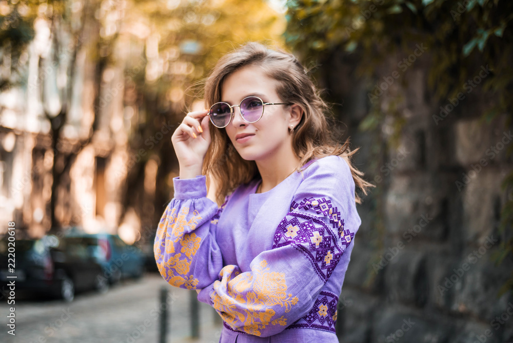 Portrait of cheerful Ukrainian girl wearing national embroidered shirt. Autumn portrait of cute curly teenage girl. Portrait of cheerful Ukrainian girl wearing national embroidered shirt. Autumn portrait of cute curly teenage girl.