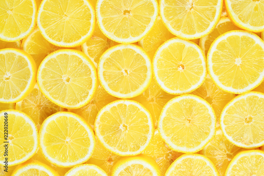 A slices of fresh juicy yellow lemons.  Texture background, pattern.