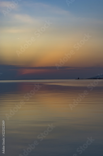 Sunset sky is mirroring in the sea surface. © Petr