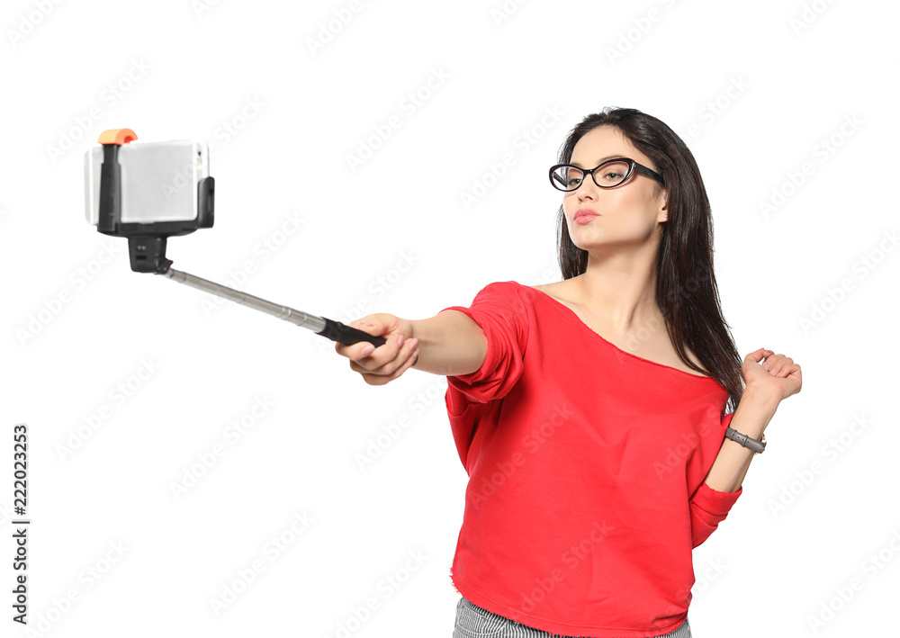 Attractive young woman taking selfie on white background Attractive young woman taking selfie on white background