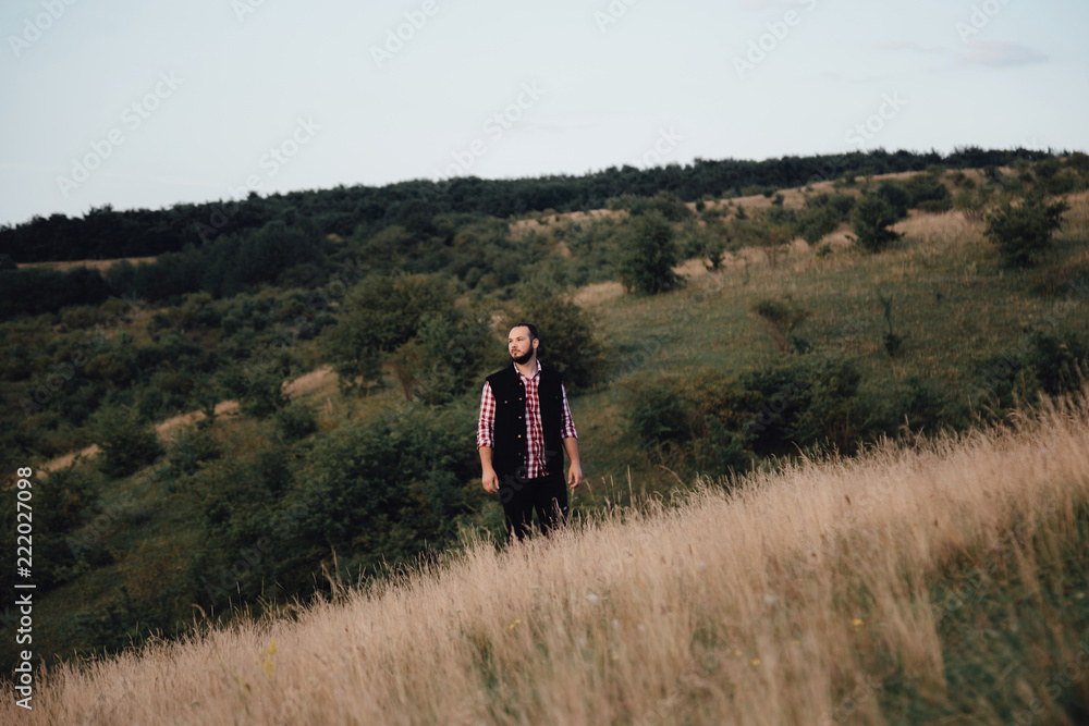 a man hipster walks in an autumn park a man hipster walks in an autumn park