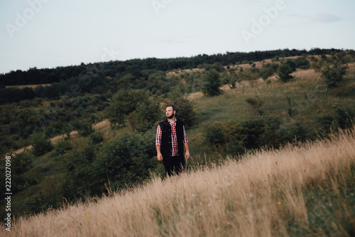 a man hipster walks in an autumn park