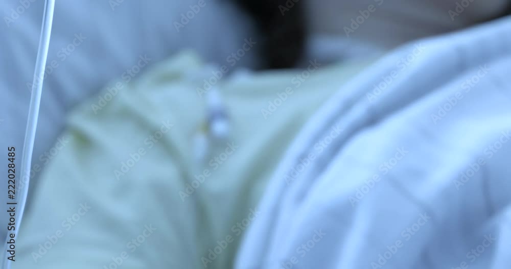 A young girl lies in a post-operative room on a hospital bed. It has a special honeycomb dress. Rests after spine surgery, scoliosis. A young girl lies in a post-operative room on a hospital bed. It has a special honeycomb dress. Rests after spine surgery, scoliosis.