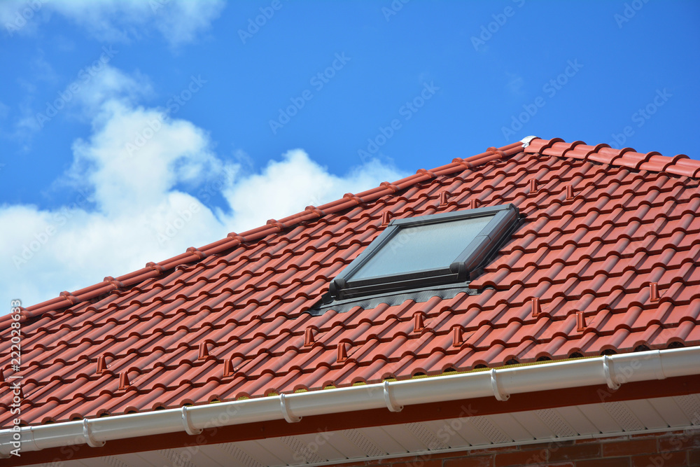 Attic skylight. Roof Tiles House Roofing Construction with Attic Roof windows, skylight waterproofing.
