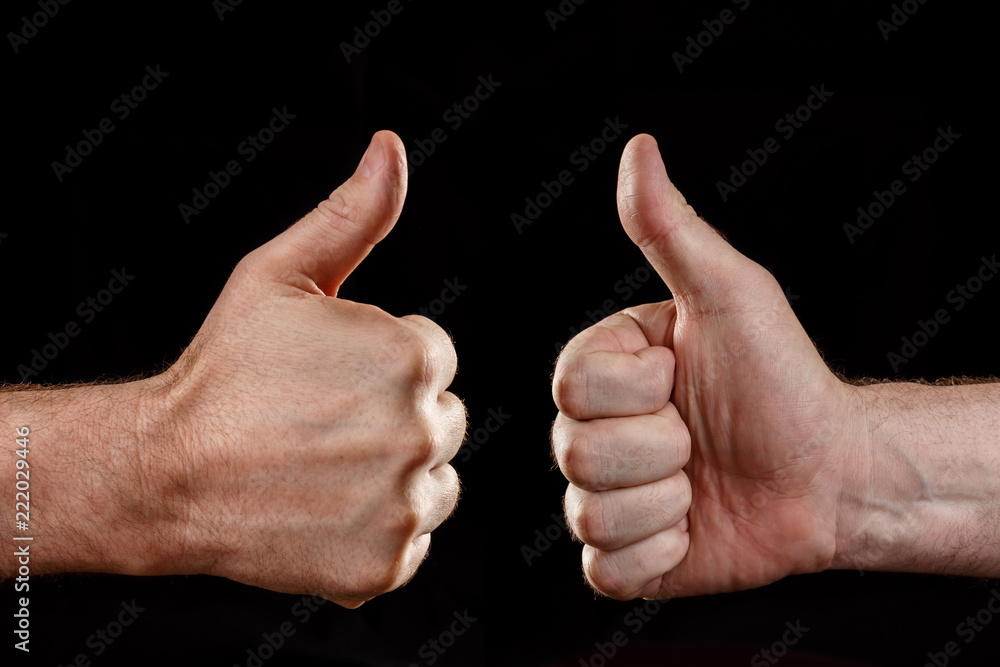 Two hands showing approval, on a black background Two hands showing approval, on a black background