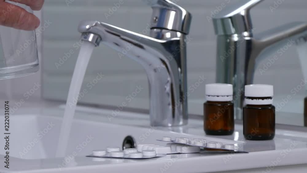 Man Preparing to Take a Lot of Pills with Fresh Water Man Preparing to Take a Lot of Pills with Fresh Water