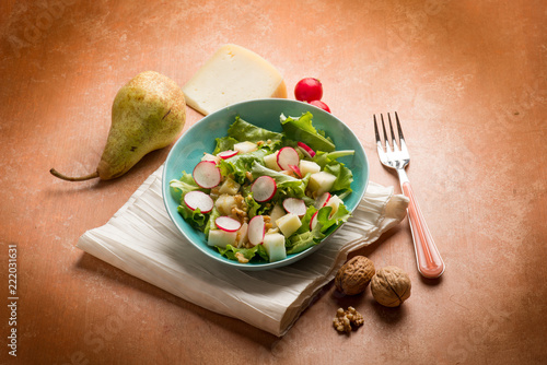 salad with cheese pear radish lettuce and nuts photo