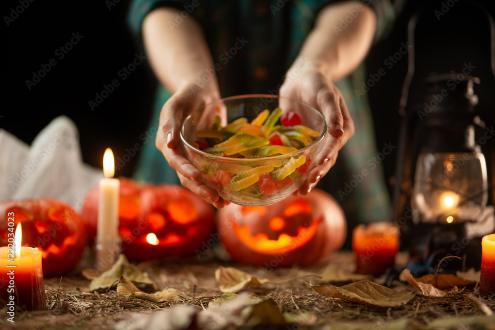 preparation for halloween, sweets on a pumpkin background