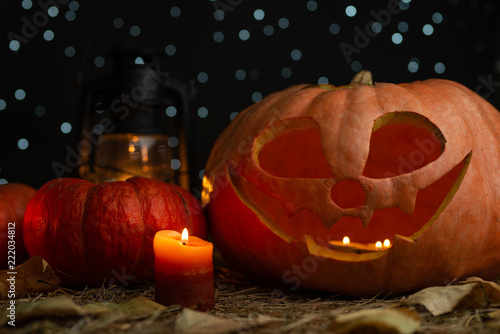 Pumpkin with candles, lantern and stars. Halloween photo