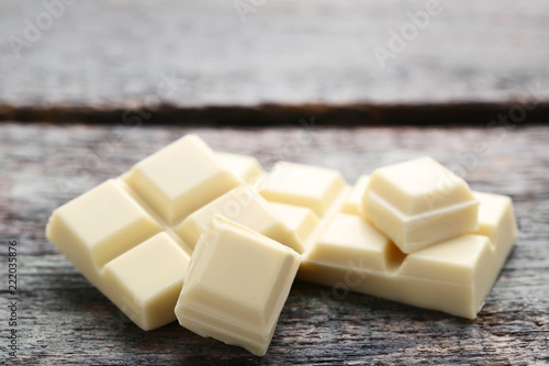 White chocolate pieces on grey wooden table