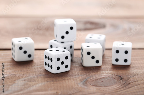 White dice on brown wooden table