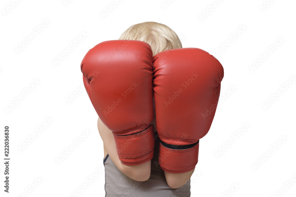 Blond boy is protected in two boxing gloves. Portrait.  Isolate