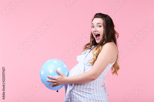 Beautiful pregnant woman with rubber balloon on pink background © 5second