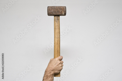 Tableau sur toile Old sledgehammer in a man's hand. White background