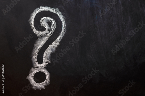 hand drawing question mark on blackboard