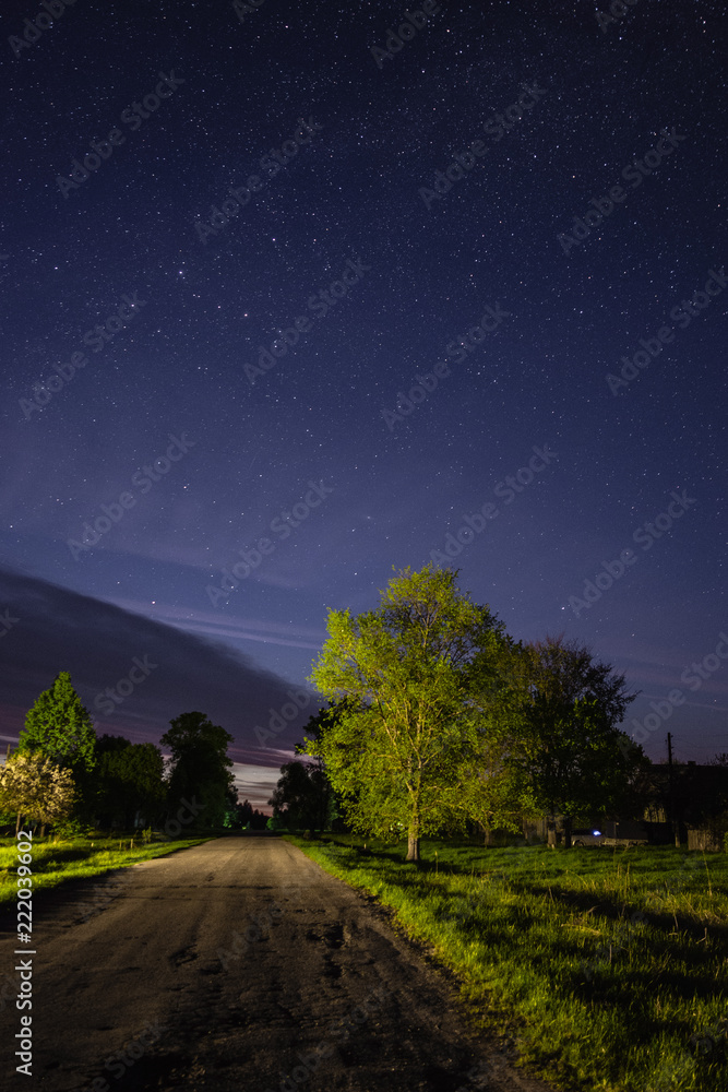 Starry sky over the road in the village Starry sky over the road in the village