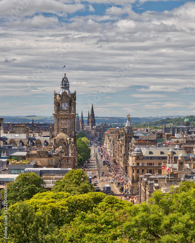 View from Calton Hill of busy Princes Street in Edinburgh, Scotland with a blue sky and white clouds
