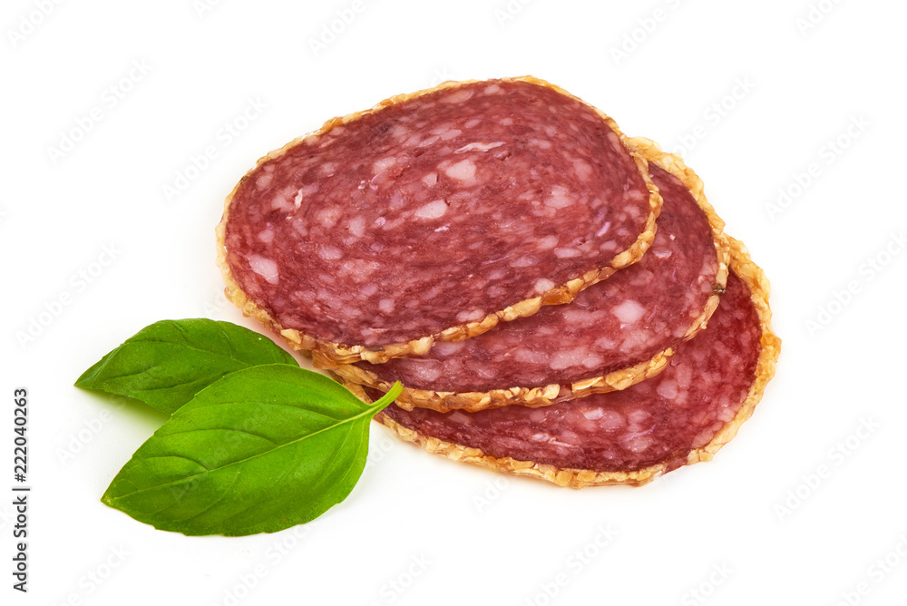 Smoked salami sausages slices with basil leaves, isolated on white background Smoked salami sausages slices with basil leaves, isolated on white background