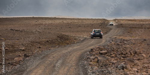 offroad car on Kaldidalur valley, road 52 to Fanntófell, Iceland highlands, with rough volcanic landscape  photo