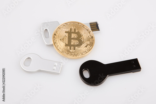 Golden bitcoin and USB flash drive isolated and protecting of electronic crypto currency